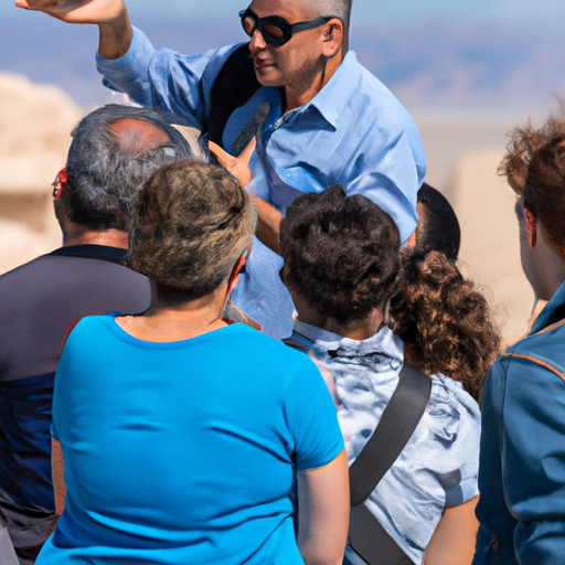 A local guide sharing his knowledge about the historical significance of Masada with a group of interested listeners